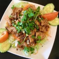 Pad Kratiem (Garlic & Pepper) · Stir-fried with Garlic and Pepper on top of mixed salad.