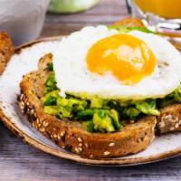 Avocado Toast with Poached Eggs · Our thick-cut sourdough toast topped with fresh smashed avocado, poached eggs, arugula, and ...