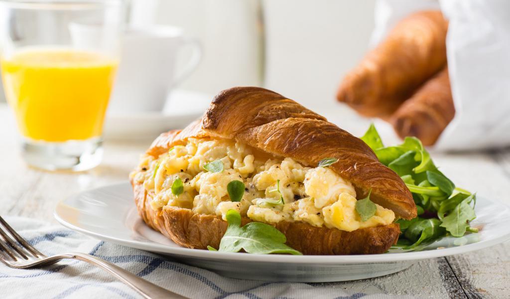 Croissant With Egg, Cheese & Sausage · Delicious croissant sandwich with fresh egg, creamy cheese and satisfying sausage.