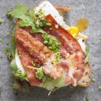 Avocado Toast with Bacon · Our thick-cut sourdough toast topped with fresh smashed avocado, crispy bacon, arugula, and ...