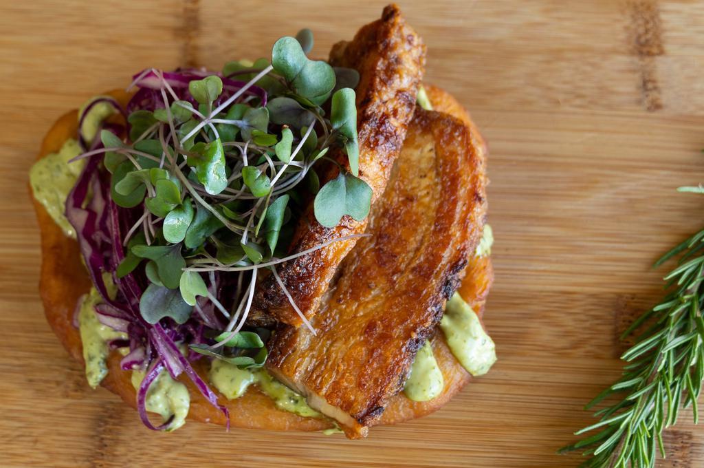 1) Pork Belly · Salted and slow roasted pork belly, chimichurri aioli, red cabbage slaw and micro-greens.