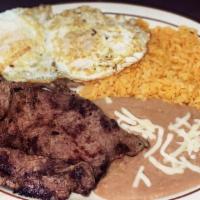 Huevo con Bistec · Fried eggs and grilled steak served with rice,  beans and tortillas