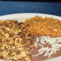 Huevos con Chorizo · Mexican sausage and scrambled eggs  served with rice, refried Beans and tortillas