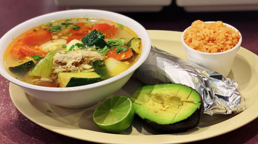 Caldo de pollo/Chicken soup · Served with rice, lime, avocado and tortillas