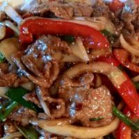 Mongolian Beef · Slices of beef filet sauteed with fresh onion, bell pepper in a spicy dark seasoned sauce. S...