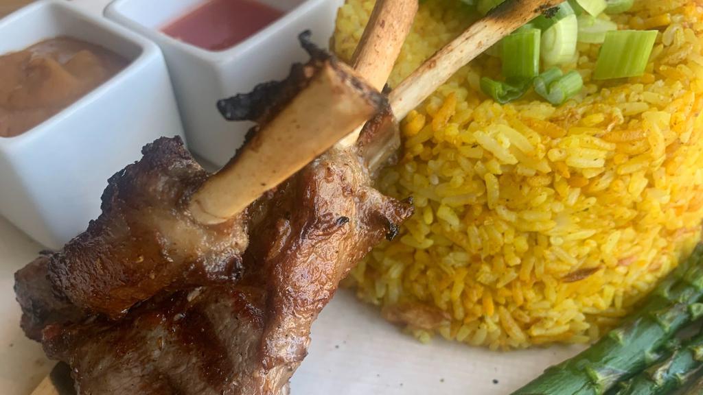 Khao Mok Lamb · Grilled Rack of Lamb.Comes with yellow curry spice Rice,asparagus, peanut sauce,lime sauce, cucumber soup