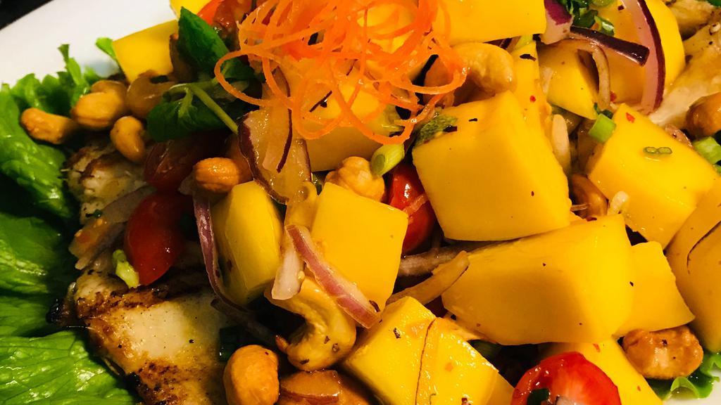 Trout with Mango Salad · Grilled whole Trout topped with Mango Salad (Mango , red onion,green onion ,cherry tomato,cashew nuts,mint leaves ,garlic lime dressing)