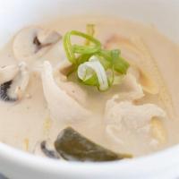 Tom Kha Gai · Coconut milk soup with chicken, lemongrass, galanga, kiffir lime leaves, green onion and mus...