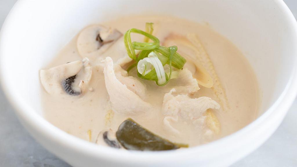 Tom Kha Gai · Coconut milk soup with chicken, lemongrass, galanga, kiffir lime leaves, green onion and mushroom.