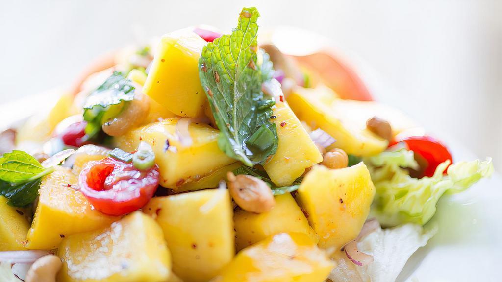 Mango Salad · Spicy. Fresh mango, cherry tomatoes, mint, onion, cashew nuts and crushed chili tossed with house garlic lime dressing.