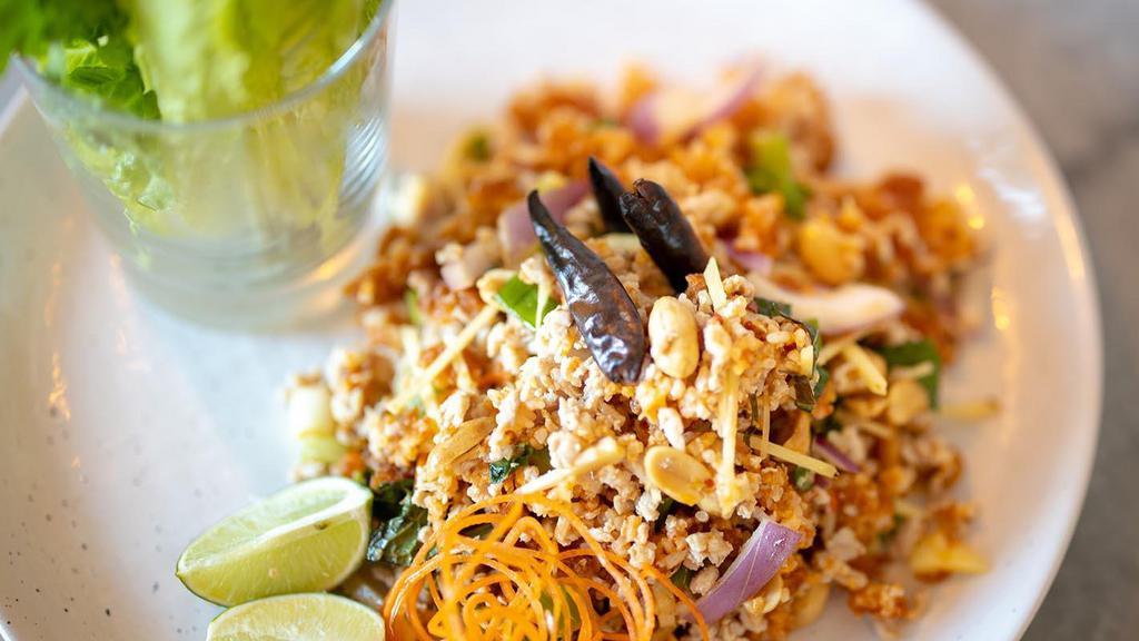Crispy Rice Salad(Yum Nam Kao Tod) · Crispy rice,minced chicken,onion,roasted chili,coconut meat,mint leaves,ginger,lime dressing,green leaves lettuce
