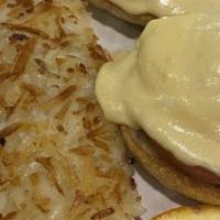 Eggs Benedict · Two poached eggs on a toasted English muffin, Canadian bacon, crowned with our creamy hollan...