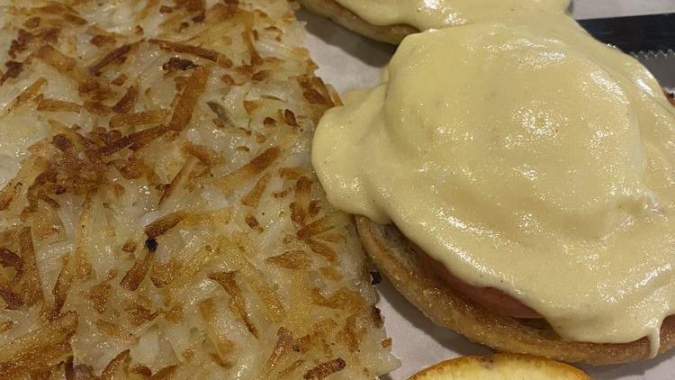 Eggs Benedict · Two poached eggs on a toasted English muffin, Canadian bacon, crowned with our creamy hollandaise sauce.