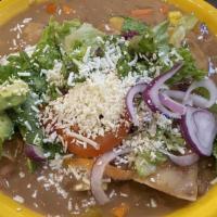 Enfrijoladas (3) · Corn Tortillas Dipped in Bean Sauce Filled Then Topped with Cheese, Lettuce, Tomato, Red Oni...