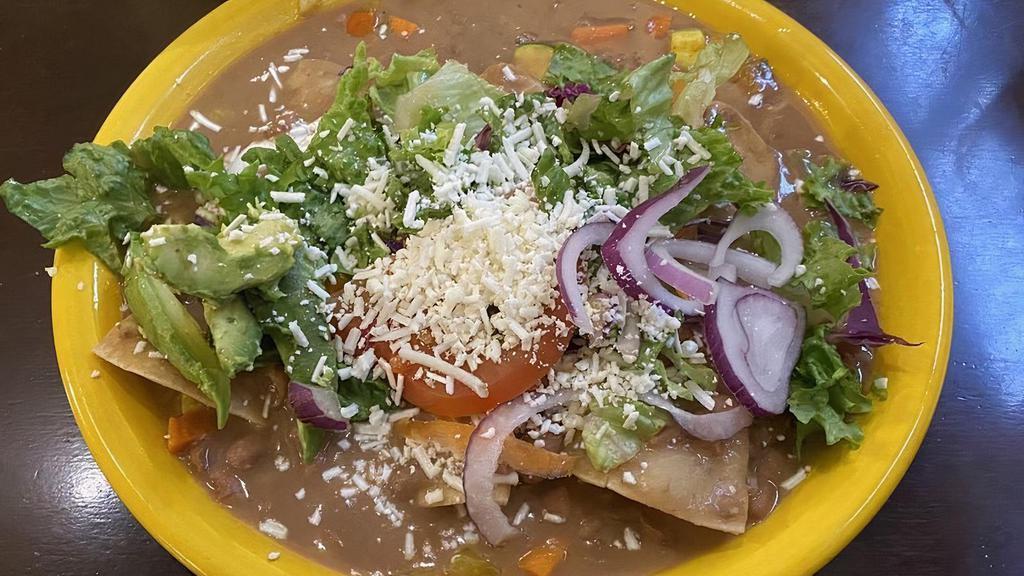 Enfrijoladas (3) · Corn Tortillas Dipped in Bean Sauce Filled Then Topped with Cheese, Lettuce, Tomato, Red Onion and Avocado.