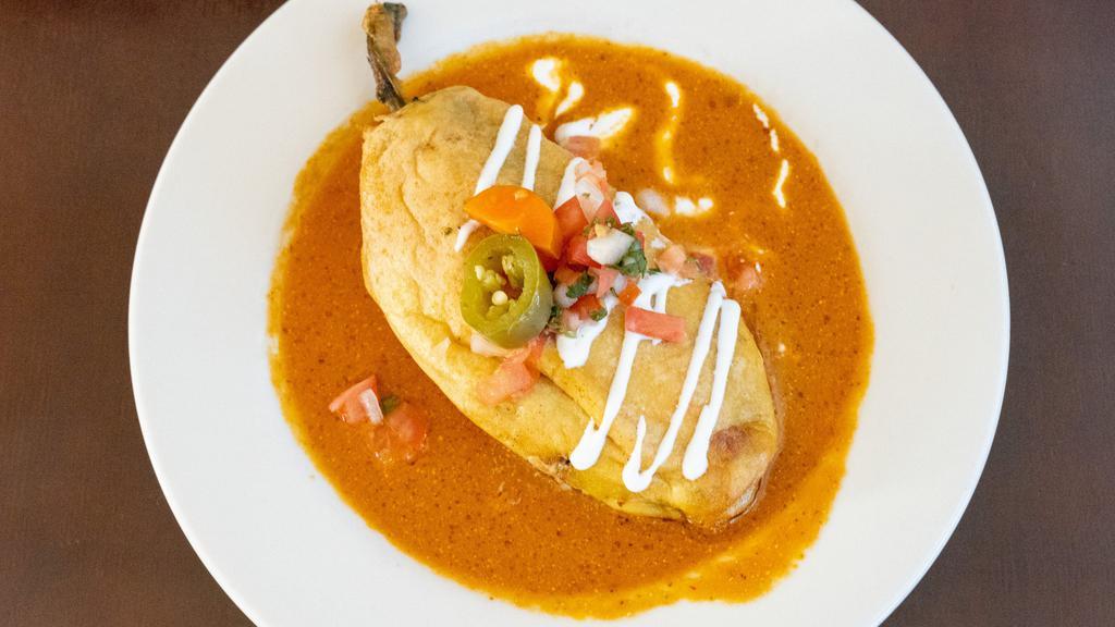 Chile Relleno · Chile Relleno filled with vegetables(carrots, zucchinis, onions, bell peppers) and cheese. Chipotle sauce, sour cream, cotija cheese, pico de gallo and side of rice and beans.