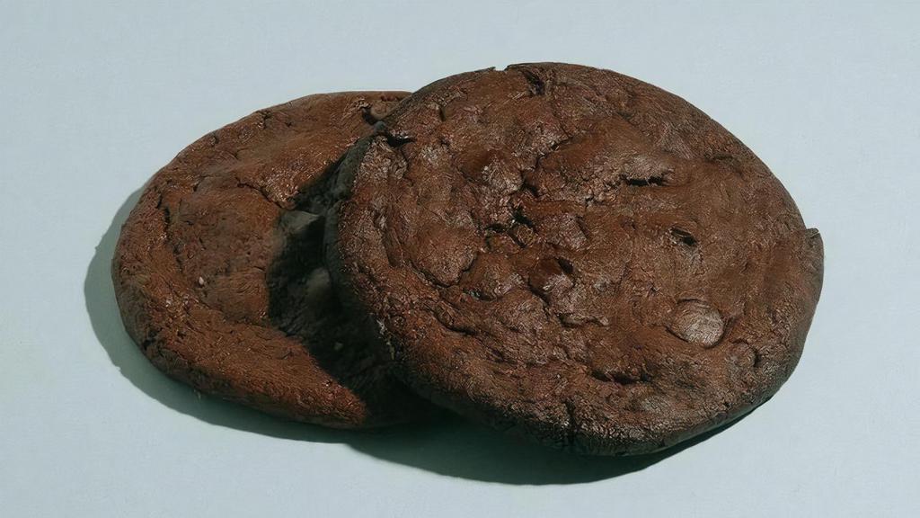 Vegan Double Chocolate Cookie · No joke. These cookies are the epitome of soft, gooey, fudgy, chocolatey goodness. Double dose of fair – trade chocolate and a chewy sweet and salty dough create a beautiful marriage. Close your eyes, you would not know it was Vegan.