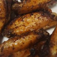 Jerk Chicken Wings · Jerk marinated chicken wings grilled and served with jerk sauce.