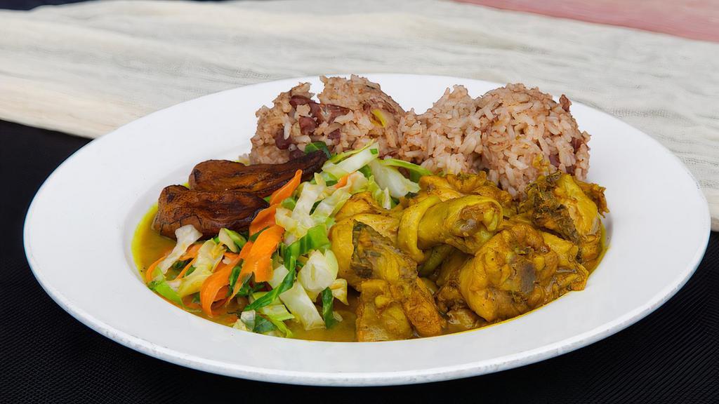 Curried Chicken Meal · Tender cubes of bone in chicken in savory curry sauce served with rice and peas, sautéed vegetable and plantain.