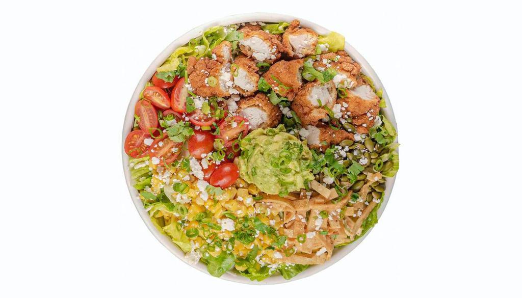 Chicken Chop · Crispy Chicken, tomatoes, roasted corn, avocado mash, pepitas, crispy tortillas, cotija, cilantro, green onions, Chipotle Lime Dressing