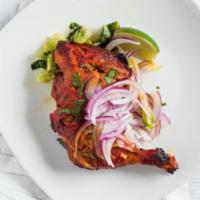 CHICKEN TIKKA LEG · Chicken Leg quarter marinated in exotic spices and yogurt cooked in tandoori over served wit...
