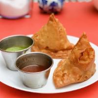Vegetable Samosa · Samosa filled with tomato, peas and spices.