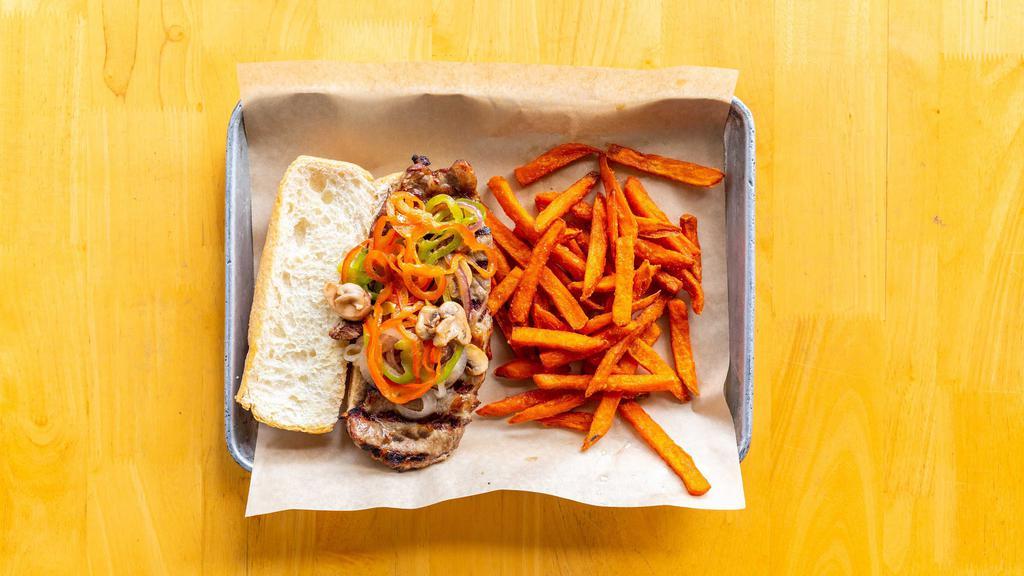 New York Steak Sandwich · Grilled NY steak strip with sauteed onions and bell peppers on a sourdough sandwich roll.