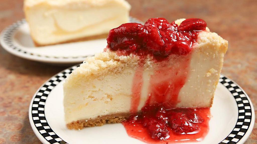 Lemon Drop Cheesecake · Lemon cheesecake swirled with lemon curd, baked in a vanilla crumb and finished with buttery streusel topping.  Served as is or topped with strawberry dessert topping.