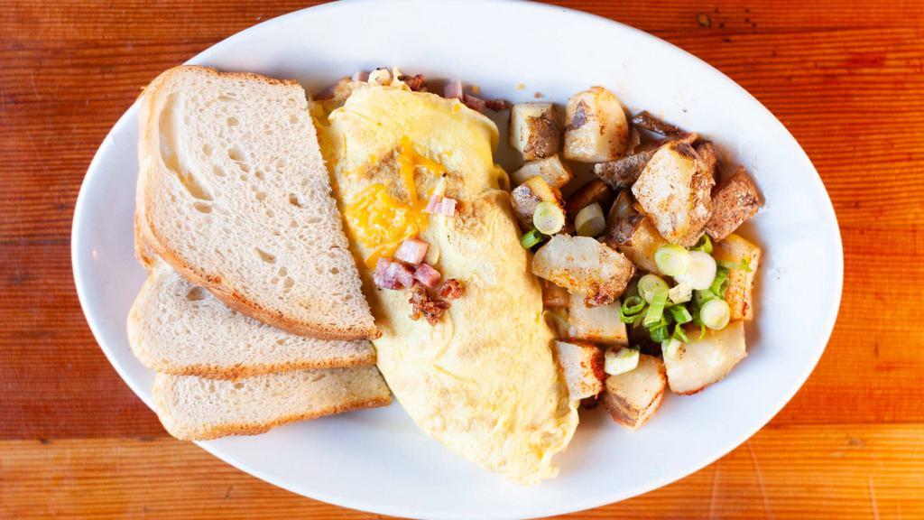 Build Your Own Omelet · Three large eggs with your choice of cheese, mushrooms, ham, bacon, sour cream, avocado or sausage. Served with made-to-order home fries and your choice of toast.