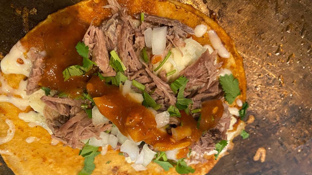 NEW! Quesibirria · Taco style corn tortilla filled with jack cheese and choice of meat topped with onions, cilantro and red salsa broth on the side to dip taco !