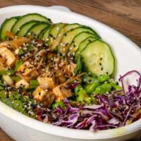 TOFU POKE BOWL · roasted tofu tossed with dynamite sauce, over brown rice with edamame, shaved cabbage, avoca...