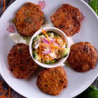 Fish Cakes · Mild.Deep fried homemade Thai fish patty, green bean and shredded kaffir leaves served with ...