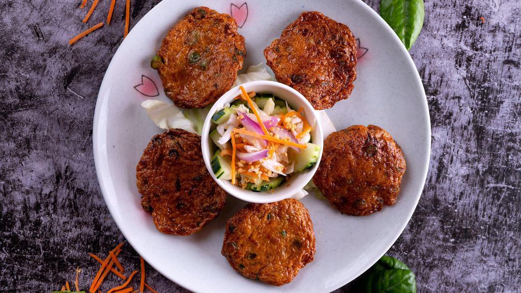 Fish Cakes · Mild.Deep fried homemade Thai fish patty, green bean and shredded kaffir leaves served with cucumber salad and chopped peanuts.