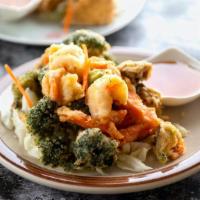 Kung Tod (Fried Prawns & Veggies) · Prawns, carrots, mushrooms and broccoli battered and crisply deep-fried served w/sweet & sou...