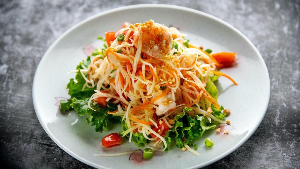 Papaya Salad · Medium.Shredded green papaya, prawns, carrot, tomato  with lime juice and chili dressing topped with ground peanuts and green beans over lettuce.