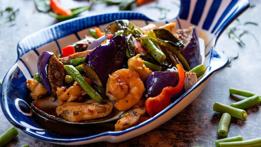 Spicy Eggplant · Eggplant sautéed with onions, green beans, carrots, red bell peppers with Thai basil and chili.