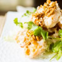 Walnut Prawns · Lightly battered prawns tossed in a honey mayonnaise mixture & sprinkled w/ honey coated Cal...