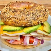 Turkey Avocado Melt Sandwich · Mayo, mustard, tomato, onion, avocado, cheese and turkey breast. If the bagels of your choic...