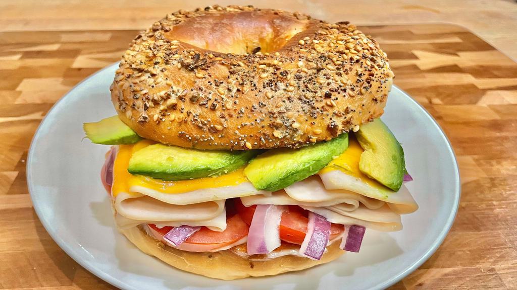 Turkey Avocado Melt Sandwich · Mayo, mustard, tomato, onion, avocado, cheese and turkey breast. If the bagels of your choice are not available, you will receive a plain bagel.