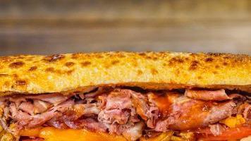 Smoked Brisket · Savory smoked brisket, house  spread,  tomatoes, green chili coleslaw, barbecue sauce, chedd...