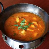 Goat Karahi · Bone-in goat sautéed with tomato, herbs, and spices-based thick curry cooked in traditional ...