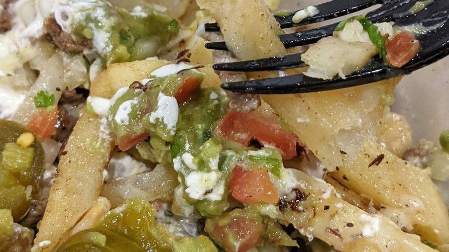 Iguana Nachos · Fresh chips, cheese sauce, choice of beans and meat, guacamole, fresh salsa, sour cream and jalapeños.