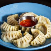 Handmade Steamed Vegetable Momo · Handmade tasty dumplings with your choice of vegetable momo or chicken momo. Served with tom...