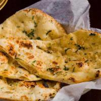 Garlic Naan · Flatbread sprinkled with crushed garlic and baked in tandoor oven.