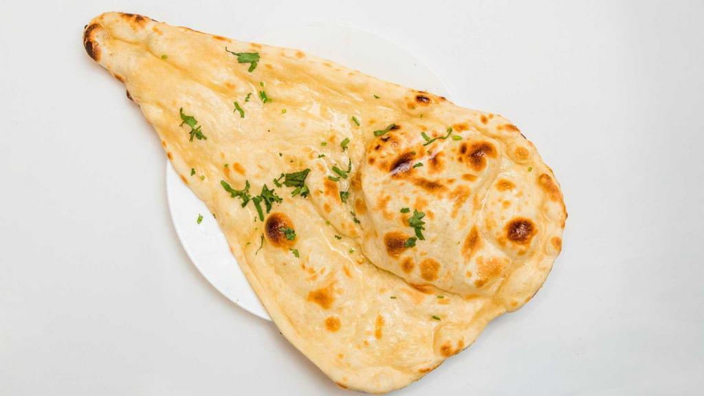 Butter Naan · Hand-stretched flatbread baked in tandoor oven finishing with butter.