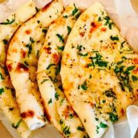 Garlic & Cheese Naan (Premium) · Flatbread sprinkled with crushed garlic and cheese and baked in tandoor oven.