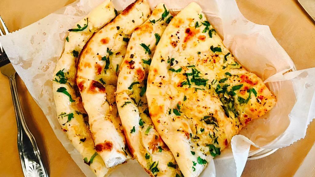 Garlic & Cheese Naan (Premium) · Flatbread sprinkled with crushed garlic and cheese and baked in tandoor oven.