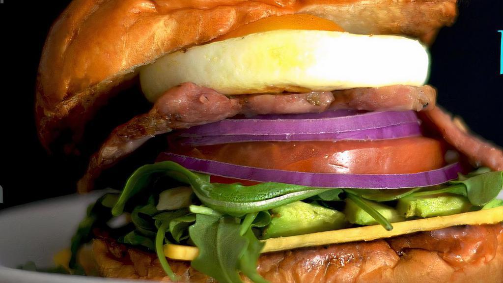 Big Blue Breakfast Sandwich · Our signature breakfast sandwich. Breakfast sausage, a soft fried egg, cheddar, avocado, tomatoes, arugula, greens and red onions on a toasted Brioche Bun