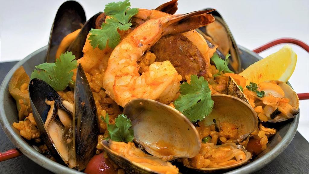 Paella · Shrimp, Clams, Mussels, Chicken & Chorizo Simmered in Saffron Stock with Spanish Rice & Peas