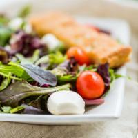 Caprese Salad · Fresh mozzarella cheese, cherry tomatoes, fresh basil, mixed greens with balsamic vinaigrette.